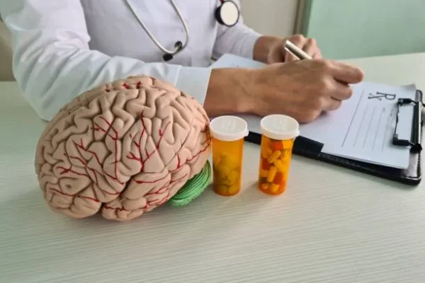 Doctora con medicinas en mano, destacando el uso de vitaminas para el cerebro y los nervios como parte esencial en el tratamiento de la salud mental.